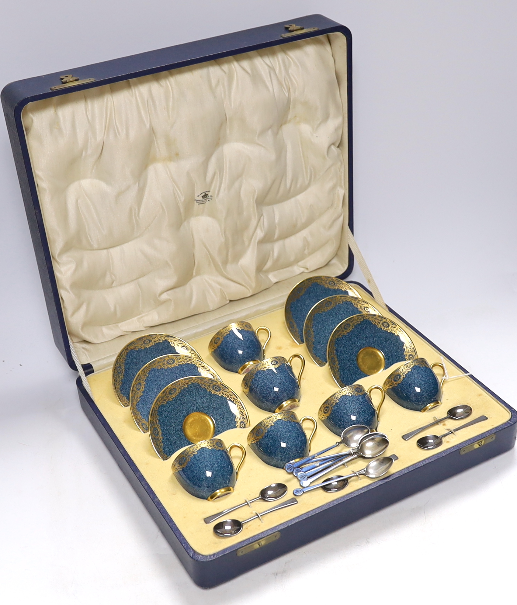 A cased Royal Worcester gilt and powder blue six piece coffee set with silver teaspoons, set of six silver and guilloche enamel teaspoons together with a Meissen blue and white ‘onion pattern’ serving dish, 39cm wide